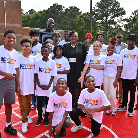 Shaquille O'Neil and a group of people (mostly young boys and girls) standing on the Henry County Comebaq Court.